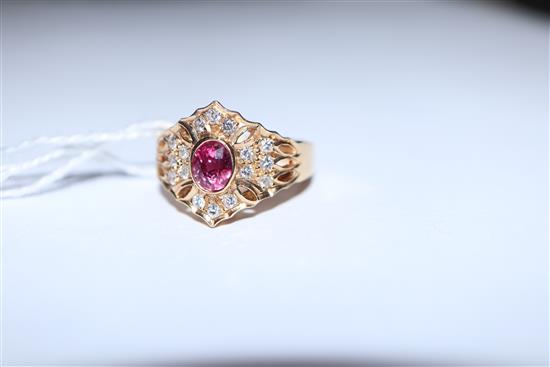 A modern pierced 14ct gold, ruby and diamond hexagonal cluster ring, size N/O.